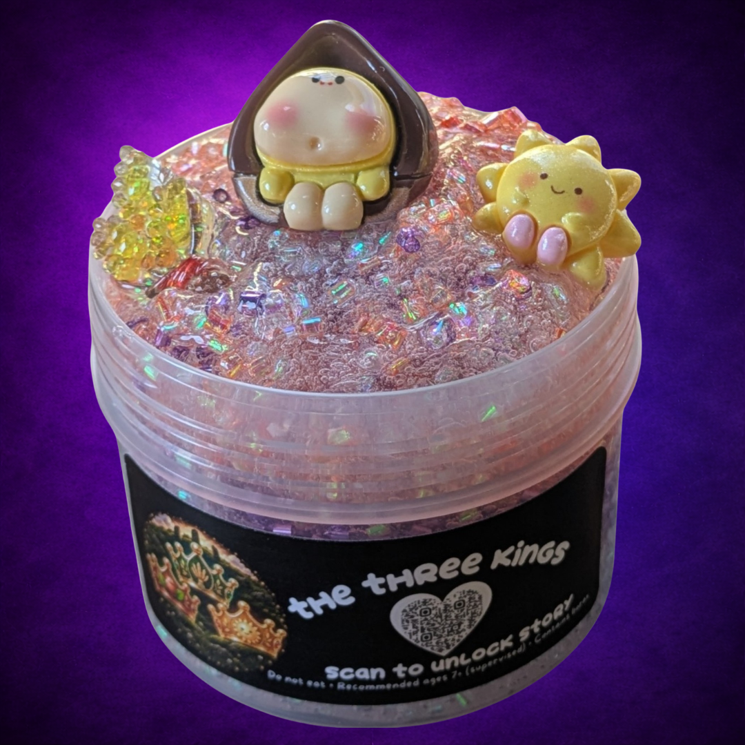The Three Kings clear bingsu slime with purple, orange and iridescent sparkle, topped with three charms.