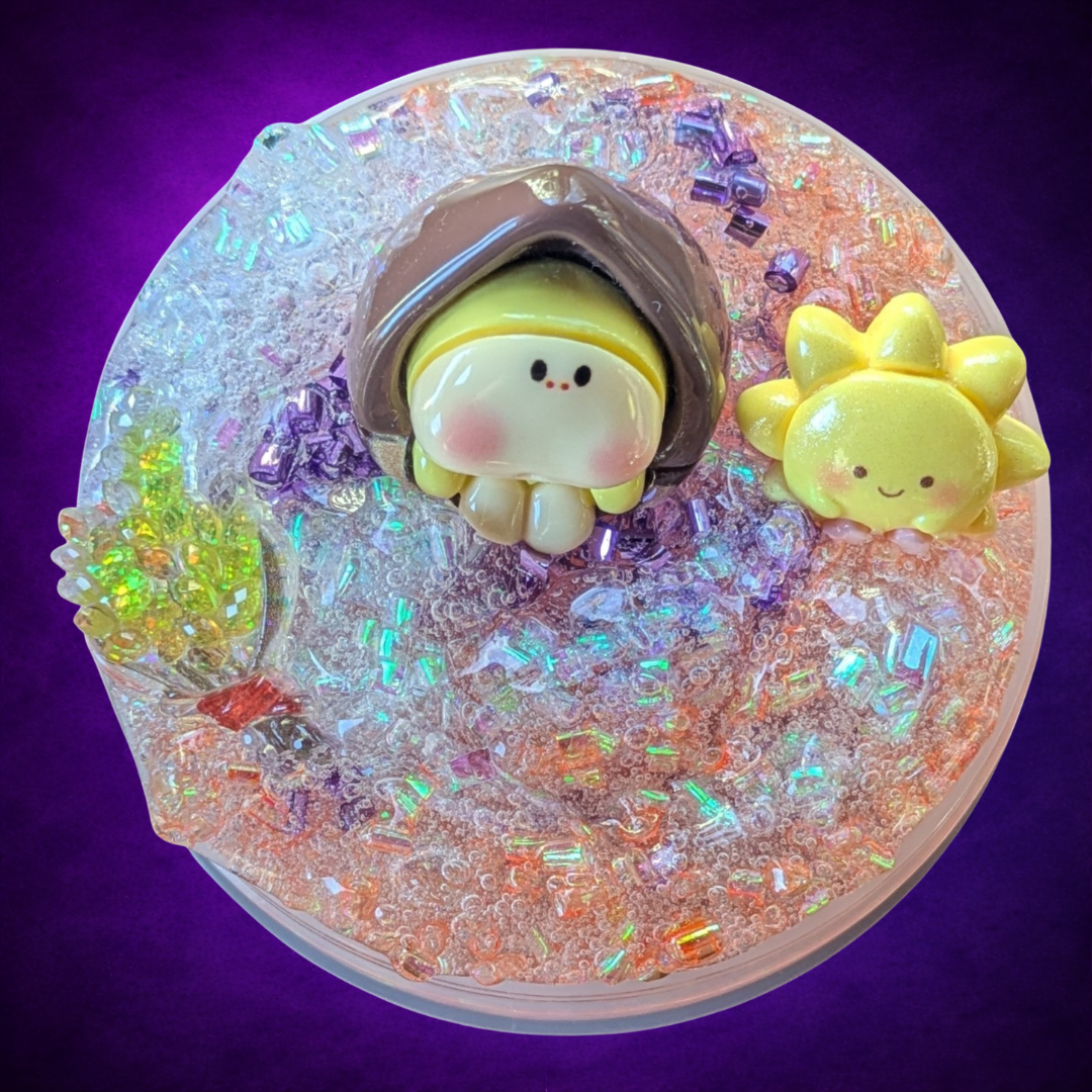 Overhead view of The Three Kings bingsu slime with a hazelnut, golden wheat and smiling sun.