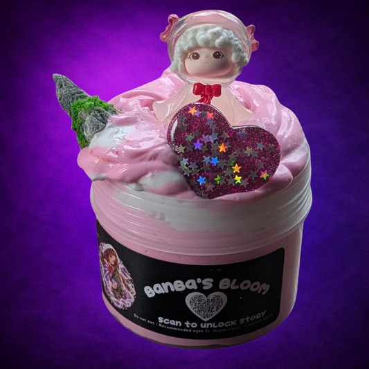 Banba’s Bloom pink and white butter slime swirl with a figure, mossy stone and pink glitter heart.